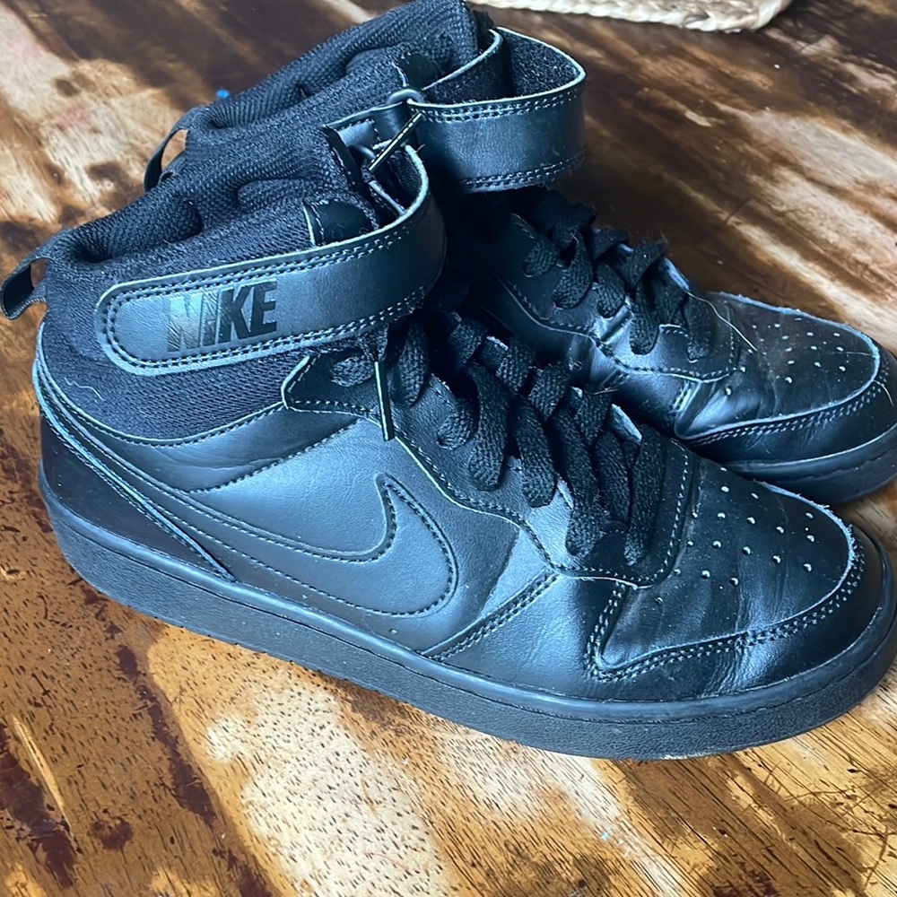 All black youth size 6Y high top Nike shoes. Good condition no tears!
